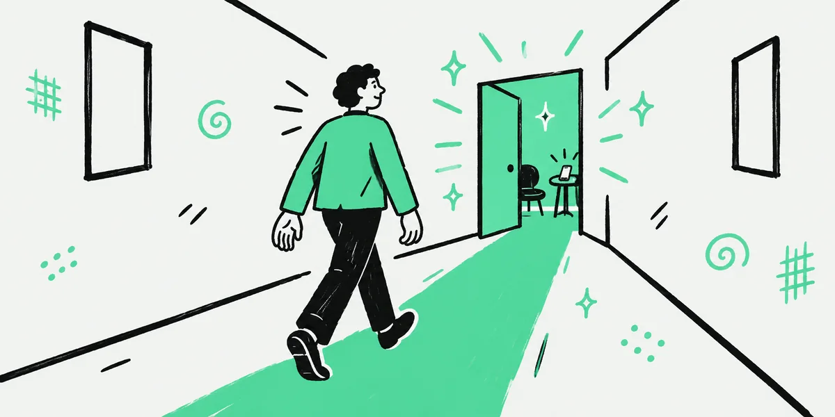 A person walking along a mint path toward a half-open door glowing with light at the end of an office corridor.